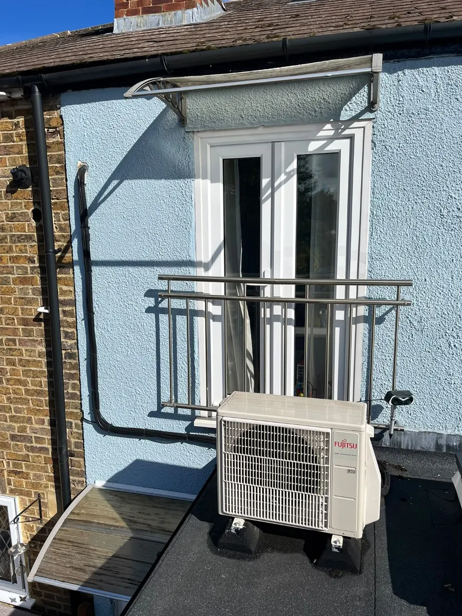 Fujitsu outdoor condenser installation showing pipework route